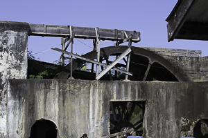 Sugar Cane being Crushed for Rum using a Waterwheel, Grenada.